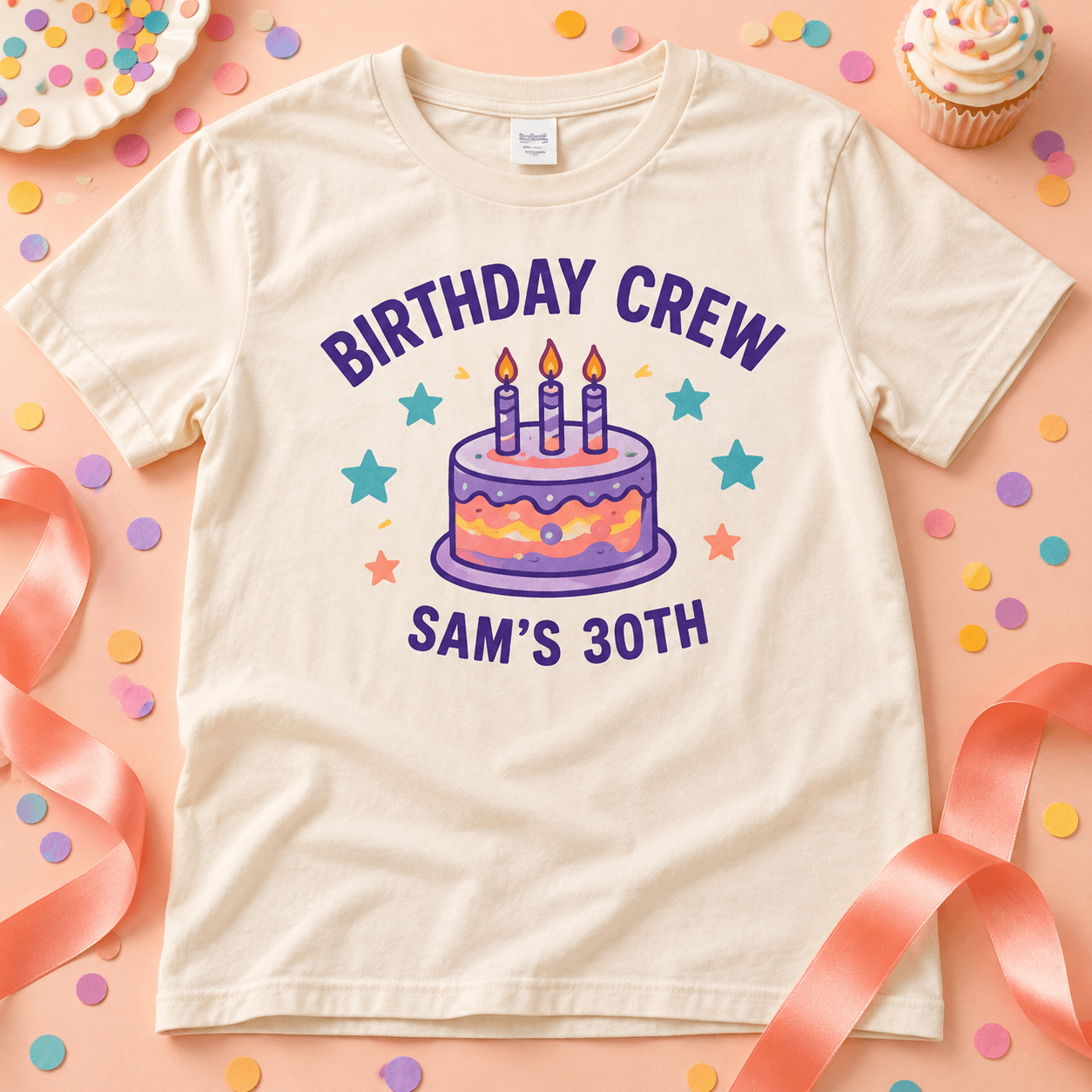 Cream Birthday Crew shirt with a cake-and-stars design and Sam’s 30th lettering on a peach party table.