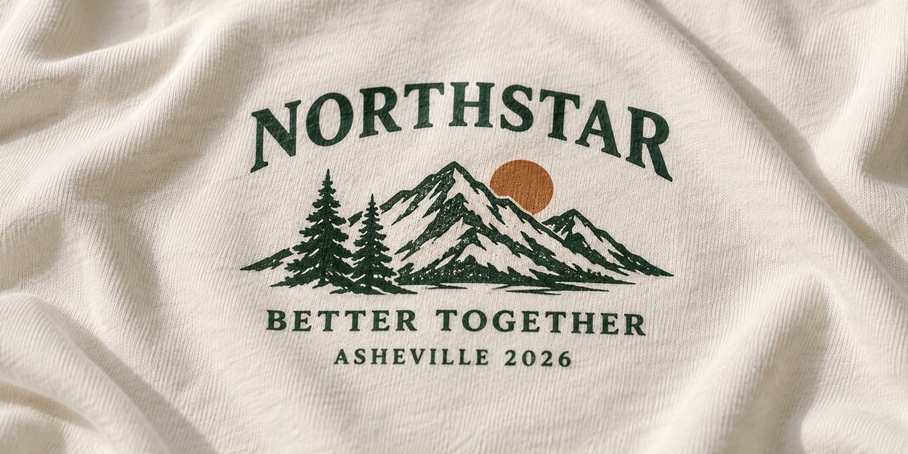 Close-up of the Northstar Better Together Asheville 2026 mountain print on cream cotton.