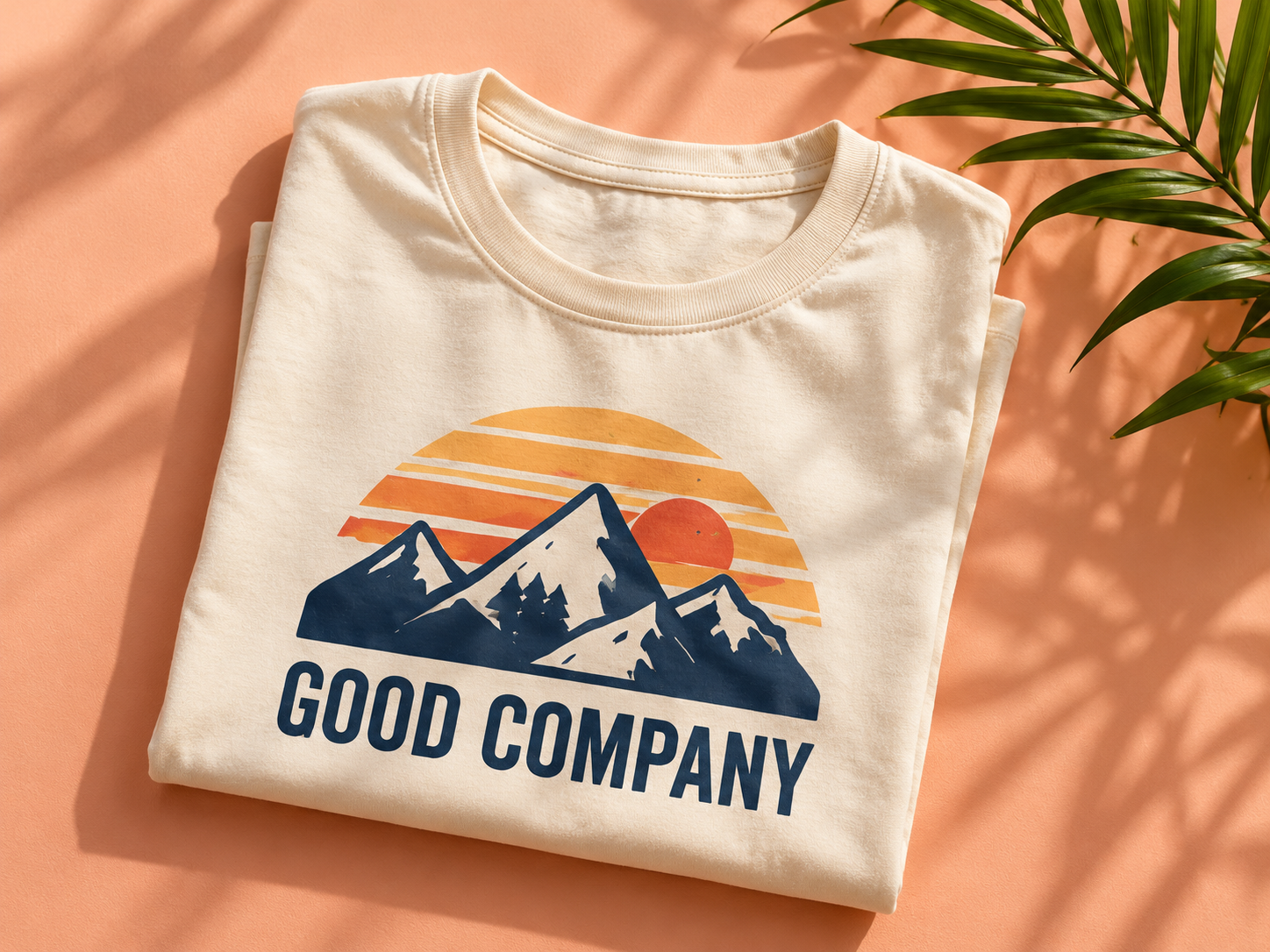 The matching Good Company design on a folded cream shirt
